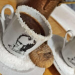 Turkish coffee served in cups with coconut rims, accompanied by sun-dried figs and dark chocolate.
