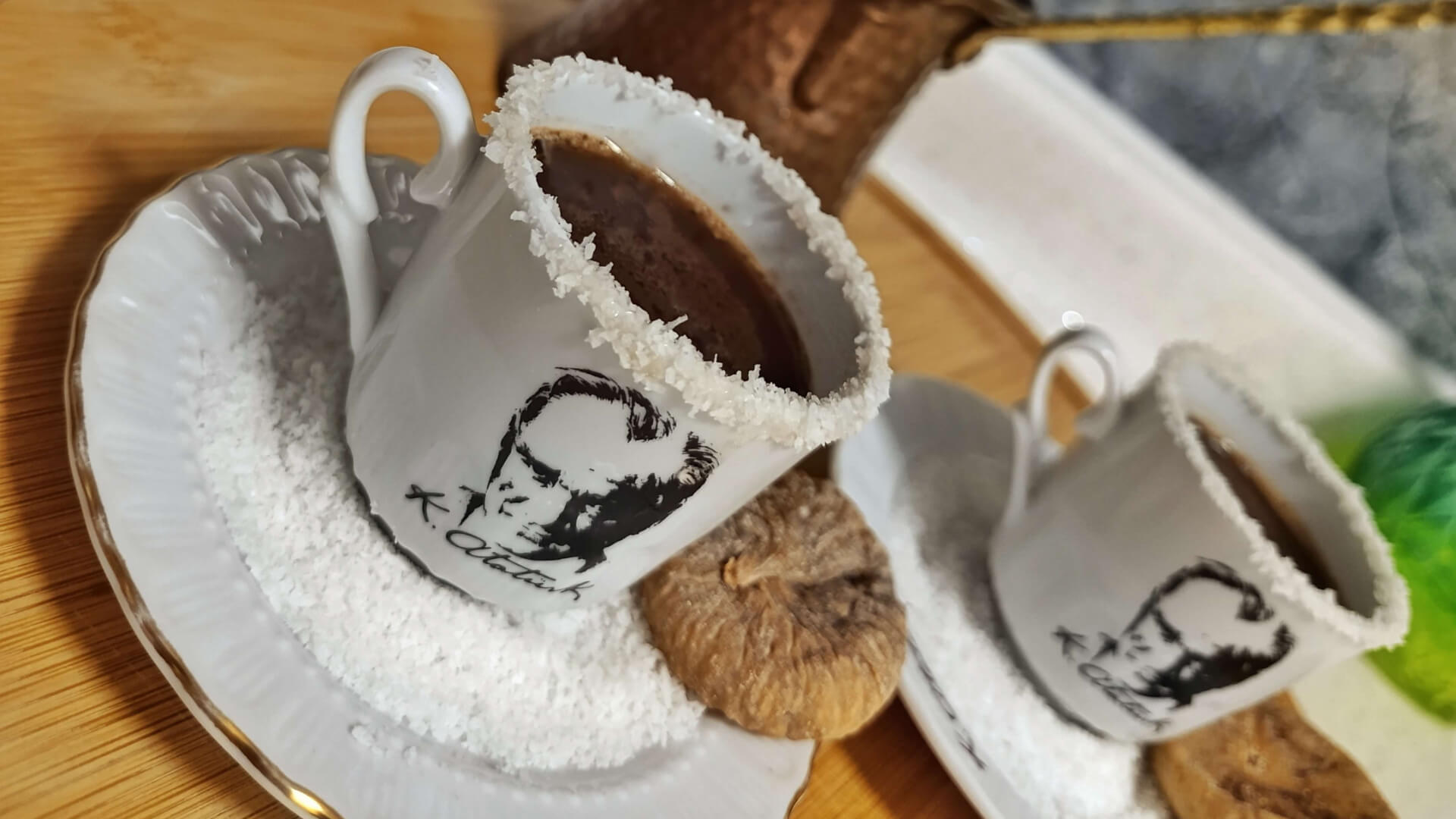 Turkish coffee served in cups with coconut rims, accompanied by sun-dried figs and dark chocolate.