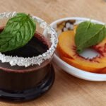 Close-up of Red Blush Mint Turkish Coffee with a coconut rim and fresh mint leaf garnish.
